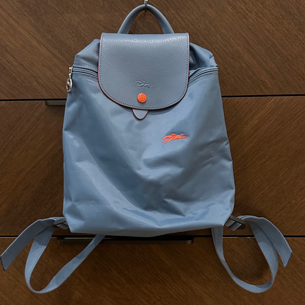 Blue Longchamp Le Pliage backpack with Orange Accents